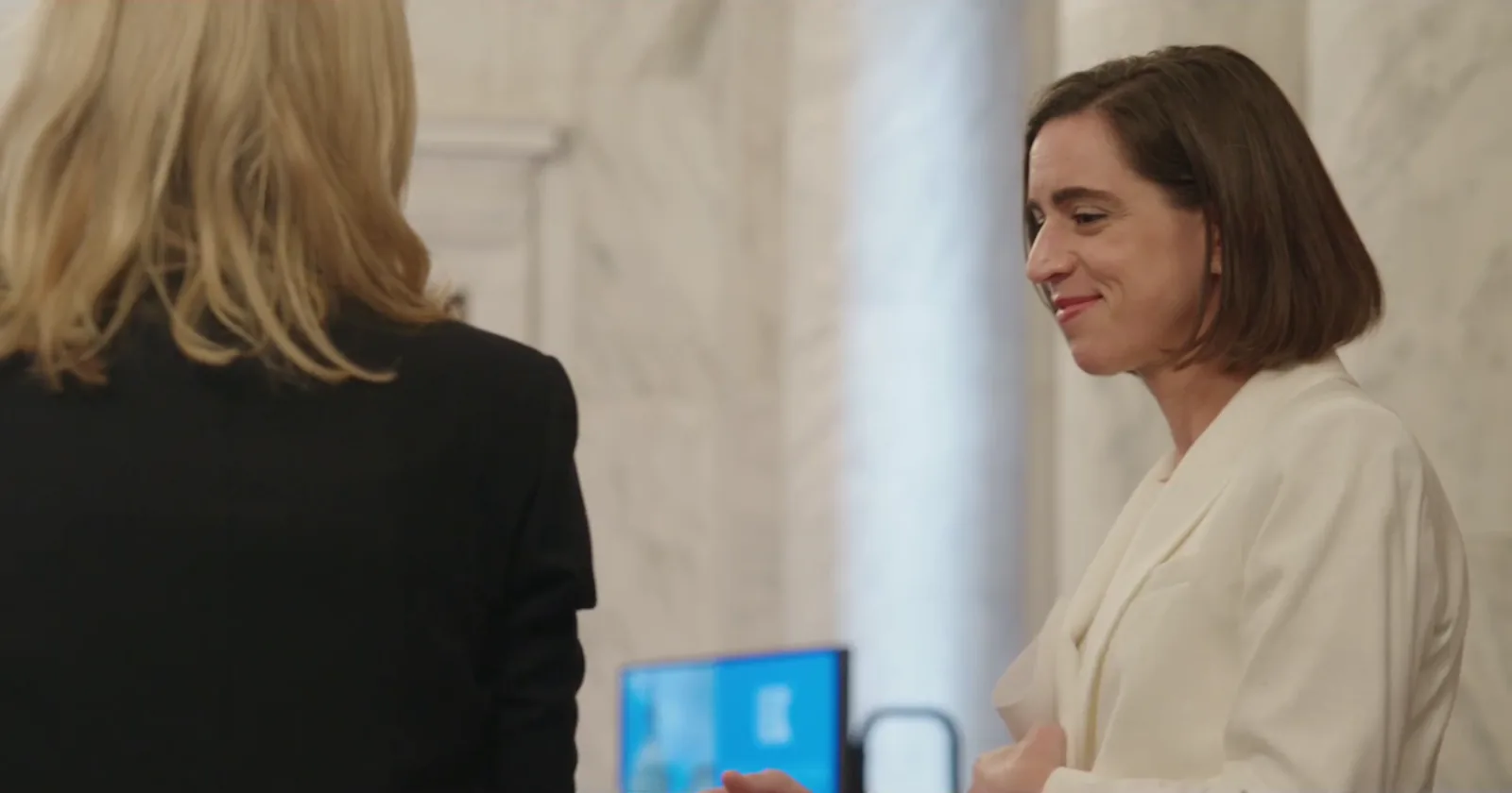 Candid moment in the Senate hallway before the ceremony